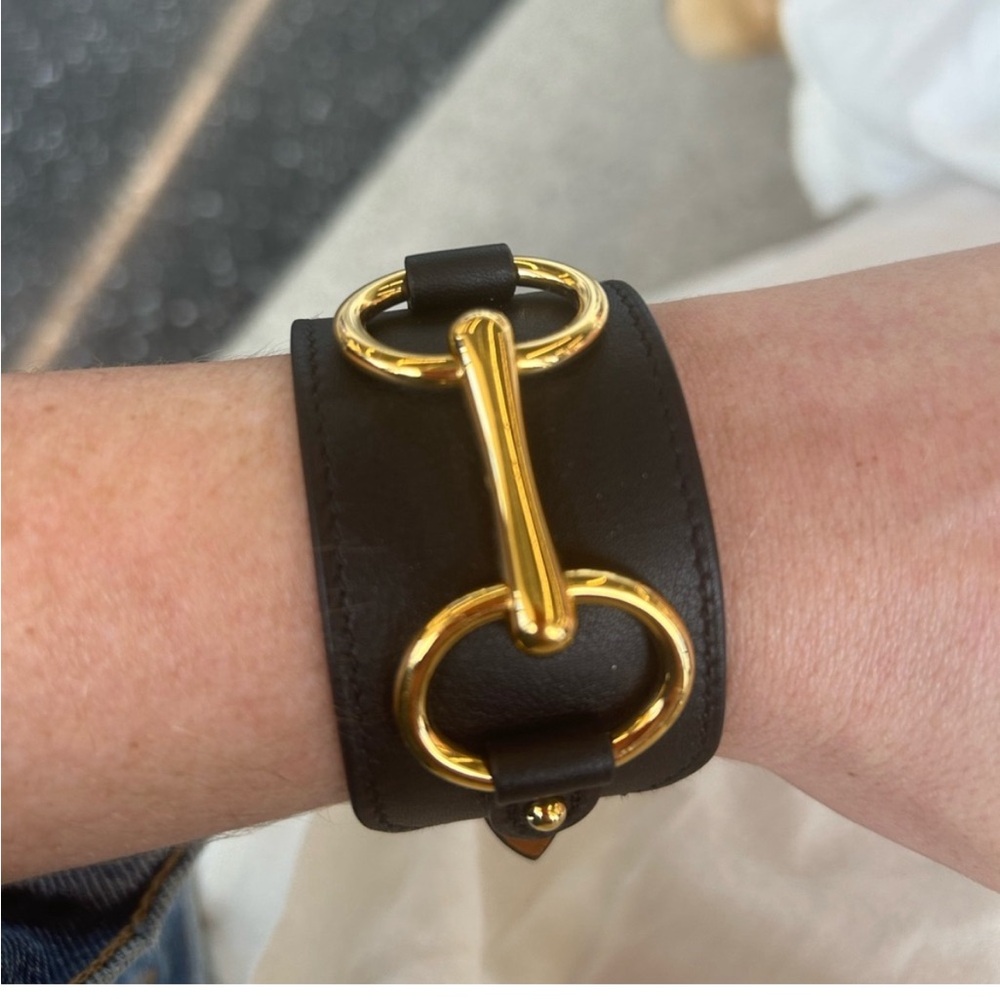 Hermes black cuff bracelet with gold horse bit detailing